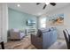 Comfortable living room featuring a gray sofa, an armchair, and a wall-mounted TV, perfect for relaxation at 8179 Coconut Pl, Kissimmee, FL 34747