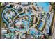 Aerial view of a water park with slides, lazy rivers, pools, lounge areas, and lush landscaping at 8179 Coconut Pl, Kissimmee, FL 34747