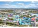 Aerial view showcasing a water park with slides, pools, and cabanas under a partly cloudy blue sky at 8179 Coconut Pl, Kissimmee, FL 34747