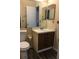 Bathroom features a single sink vanity, toilet, and dark wood-look flooring at 944 Bakewell Ct # 106, Lake Mary, FL 32746