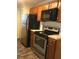 Functional kitchen featuring stainless steel appliances and wooden cabinets at 944 Bakewell Ct # 106, Lake Mary, FL 32746