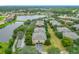 Scenic aerial view of the condominiums in a park-like setting with lush landscaping and a pond at 114 Vista Verdi Cir # 328, Lake Mary, FL 32746
