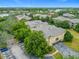 Aerial view of a multi-story condominium building with trees and community at 114 Vista Verdi Cir # 328, Lake Mary, FL 32746