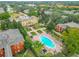 A beautiful aerial view of the community pool area, featuring mature landscaping and clubhouse at 114 Vista Verdi Cir # 328, Lake Mary, FL 32746