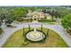 A beautifully landscaped roundabout with a water feature welcomes you to the property in this aerial view at 114 Vista Verdi Cir # 328, Lake Mary, FL 32746