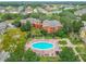This aerial view shows the pool area, including lounge chairs, lush greenery, and surrounding buildings at 114 Vista Verdi Cir # 328, Lake Mary, FL 32746