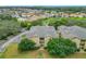 An aerial view of a condo building, showcasing a well-maintained exterior, parking, and surrounding greenery at 114 Vista Verdi Cir # 328, Lake Mary, FL 32746