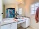 Bright bathroom with double sinks, white cabinetry, and a large mirror over the vanity at 114 Vista Verdi Cir # 328, Lake Mary, FL 32746