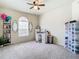 Spacious bedroom with neutral carpet, a window, ceiling fan and walk in closet at 114 Vista Verdi Cir # 328, Lake Mary, FL 32746