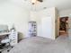 Bedroom featuring neutral carpet, a ceiling fan and closet with open doorway to living area at 114 Vista Verdi Cir # 328, Lake Mary, FL 32746