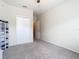 Carpeted bedroom with closet and access to adjacent living space with neutral paint at 114 Vista Verdi Cir # 328, Lake Mary, FL 32746