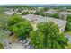 Aerial view of a multi-story condominium building with lush trees and parking at 114 Vista Verdi Cir # 328, Lake Mary, FL 32746