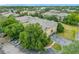Aerial view of the condominium with parking and mature trees in the community at 114 Vista Verdi Cir # 328, Lake Mary, FL 32746