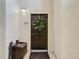 Front door of a condominium featuring a holiday wreath, bench and textured walls at 114 Vista Verdi Cir # 328, Lake Mary, FL 32746