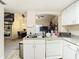 Open kitchen features a double sink with access to dining room, spiral staircase, and bedroom views at 114 Vista Verdi Cir # 328, Lake Mary, FL 32746