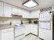 Well-lit kitchen with white cabinetry, appliances, and neutral countertops offering practical workspace at 114 Vista Verdi Cir # 328, Lake Mary, FL 32746