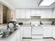 Bright kitchen with white appliances, ample counter space, and updated flooring at 114 Vista Verdi Cir # 328, Lake Mary, FL 32746