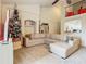 Bright living room with vaulted ceiling, neutral sectional sofa, and holiday decor on upper balcony at 114 Vista Verdi Cir # 328, Lake Mary, FL 32746