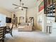 Cozy living room showing seating area, TV, decorative shelving and staircase access to the upper level at 114 Vista Verdi Cir # 328, Lake Mary, FL 32746