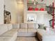 Open-concept living room with neutral tones, a large sectional, and a spiral staircase to an upstairs loft at 114 Vista Verdi Cir # 328, Lake Mary, FL 32746