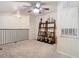 Spacious loft with ceiling fan, carpeted floors, and a decorative shelving unit for display at 114 Vista Verdi Cir # 328, Lake Mary, FL 32746