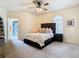 Bright and spacious main bedroom with neutral tones, ceiling fan, and arched window for natural light at 114 Vista Verdi Cir # 328, Lake Mary, FL 32746