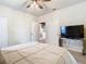 Relaxing bedroom featuring carpeted floors, ceiling fan, and en-suite bathroom access at 114 Vista Verdi Cir # 328, Lake Mary, FL 32746
