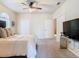 Inviting main bedroom with soft carpeting, ceiling fan, and convenient access to en-suite bathroom at 114 Vista Verdi Cir # 328, Lake Mary, FL 32746