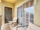Comfortable covered patio with sliding glass door to interior living space at 114 Vista Verdi Cir # 328, Lake Mary, FL 32746