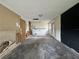 Large unfinished basement featuring a water heater, concrete floor, and a block accent wall at 115 S Lake Pleasant Rd, Apopka, FL 32703