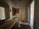 Bathroom features an old vanity, mirror, and a shower, ready to be renovated at 115 S Lake Pleasant Rd, Apopka, FL 32703