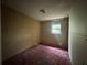 Bedroom with a window, peeling paint, and red carpet, needs some TLC but plenty of space at 115 S Lake Pleasant Rd, Apopka, FL 32703