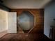 Bedroom with a built-in diamond-shaped feature and wood paneled accent wall at 115 S Lake Pleasant Rd, Apopka, FL 32703
