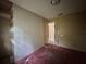 A cozy bedroom with a doorway, peeling paint, and carpeting ready for customization at 115 S Lake Pleasant Rd, Apopka, FL 32703