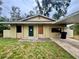 Modest single-story home with a carport and a simple landscaped yard at 115 S Lake Pleasant Rd, Apopka, FL 32703