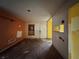 Spacious living room showcasing hardwood floors, peeling paint, and natural light from a front window at 115 S Lake Pleasant Rd, Apopka, FL 32703
