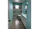Cozy bathroom featuring neutral tile and blue accent stripe in the shower and walls at 121 Loma Bonita Dr, Davenport, FL 33837
