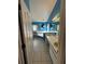 Bright blue bathroom featuring double sinks, tiled floors, a bathtub, and a glass-enclosed shower at 121 Loma Bonita Dr, Davenport, FL 33837
