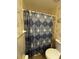 Bathroom with shower featuring blue patterned shower curtain and floral wallpaper at 121 Loma Bonita Dr, Davenport, FL 33837
