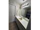 Bathroom featuring a large mirror, white vanity, and floral wallpaper at 121 Loma Bonita Dr, Davenport, FL 33837