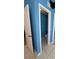 Bright blue bathroom with a toilet and mirror across from the door at 121 Loma Bonita Dr, Davenport, FL 33837