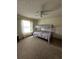 Carpeted bedroom with bunk beds, a ceiling fan, and large window at 121 Loma Bonita Dr, Davenport, FL 33837