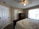 Comfortable bedroom features a plush bed, neutral walls, and ceiling fan at 121 Loma Bonita Dr, Davenport, FL 33837