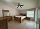 Bright bedroom with a ceiling fan, tile floors, and natural light from a sliding glass door at 121 Loma Bonita Dr, Davenport, FL 33837