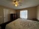 Comfortable bedroom features a plush bed, neutral walls, and ceiling fan at 121 Loma Bonita Dr, Davenport, FL 33837