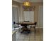 Dining area featuring a round table with four chairs and a hanging lamp at 121 Loma Bonita Dr, Davenport, FL 33837