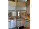 Bright kitchen featuring white cabinets, stainless steel sink and dishwasher at 121 Loma Bonita Dr, Davenport, FL 33837
