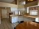 Bright kitchen featuring white cabinets and a view to the dining area at 121 Loma Bonita Dr, Davenport, FL 33837