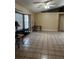 Spacious living room with tile flooring, neutral walls, a ceiling fan, and large windows for natural light at 121 Loma Bonita Dr, Davenport, FL 33837