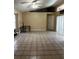 Spacious living room with tile flooring, neutral walls, a ceiling fan, and sliding glass doors for natural light at 121 Loma Bonita Dr, Davenport, FL 33837